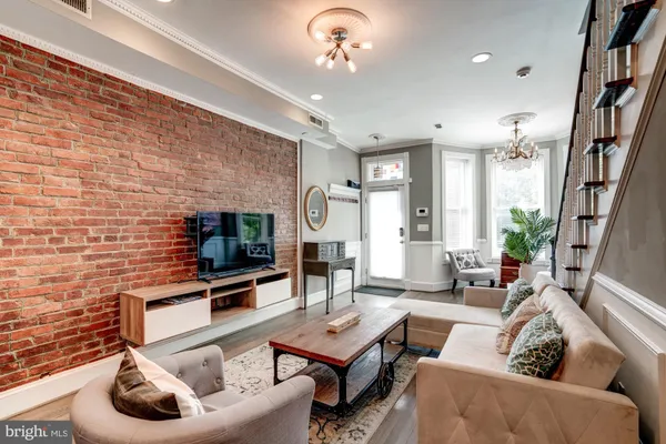 a living room with furniture a rug and a flat screen tv