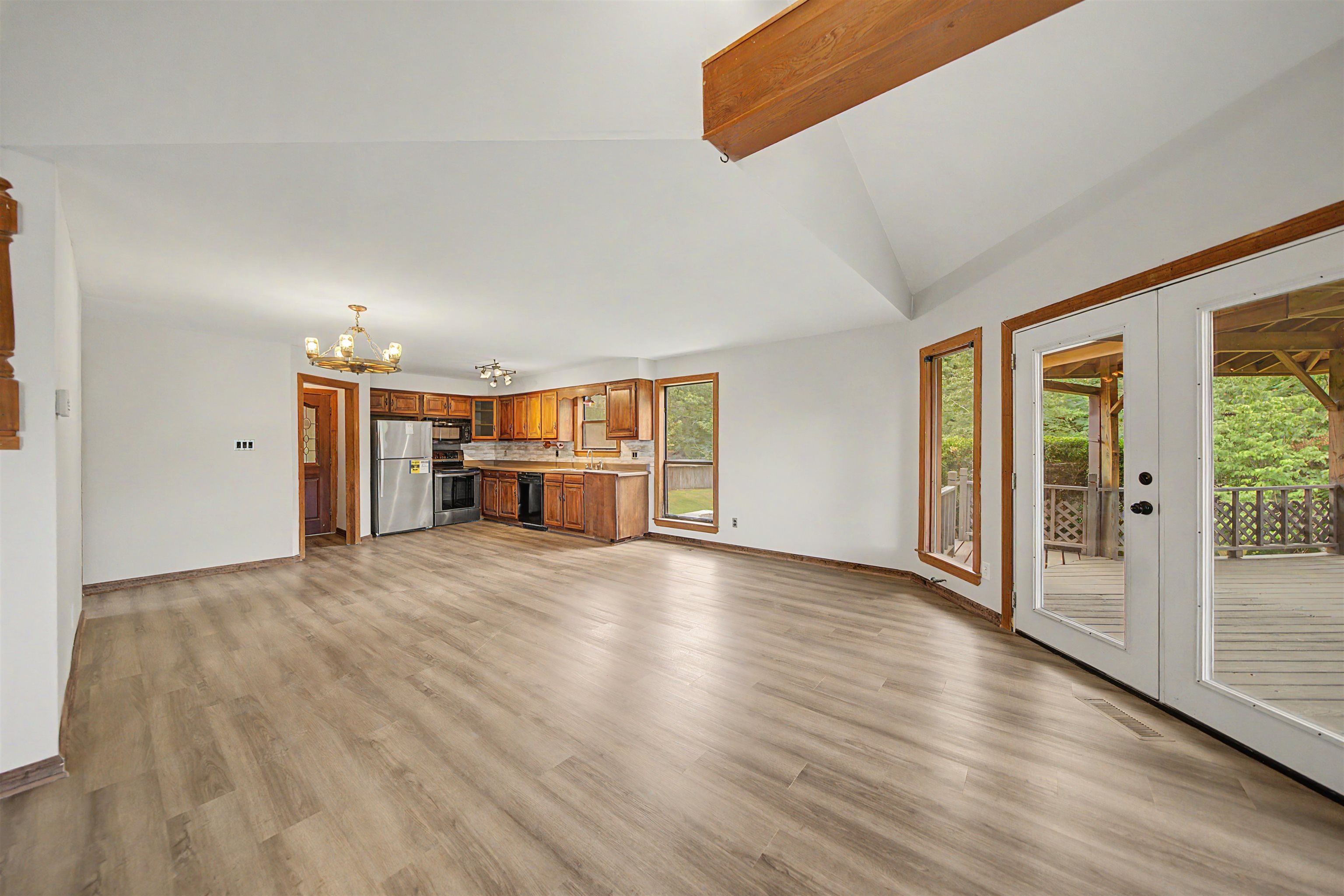 2380 Dunaway Road Selmer, TN 38375 - Photo 18 of 39 Expansive living area featuring wood-finish flooring and a vaulted ceiling with exposed wood beams