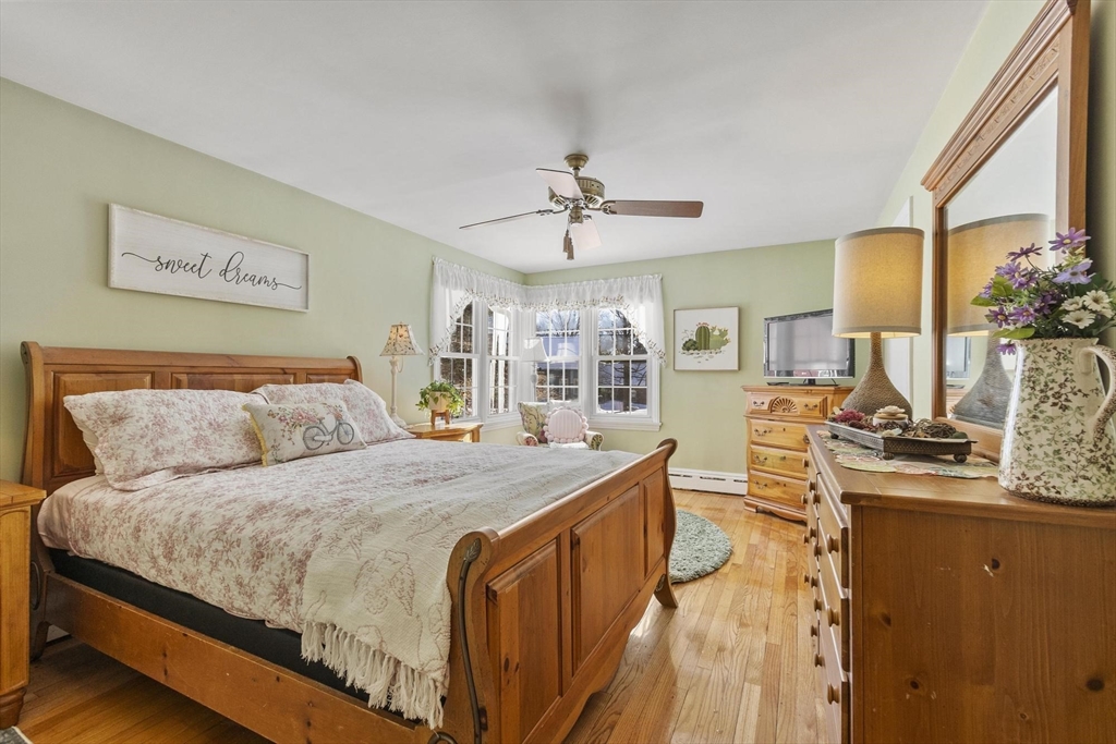 38 Knower Road Westminster, MA 01473 - Photo 11 of 40 a bedroom with a large bed and a chandelier