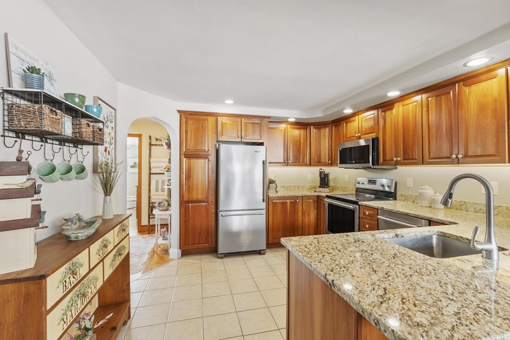 38 Knower Road Westminster, MA 01473 - Photo 19 of 40 a kitchen with stainless steel appliances granite countertop a refrigerator a sink a stove a washer dryer and cabinets