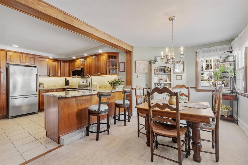 38 Knower Road Westminster, MA 01473 - Photo 25 of 40 a kitchen with stainless steel appliances kitchen island granite countertop a table chairs and a refrigerator
