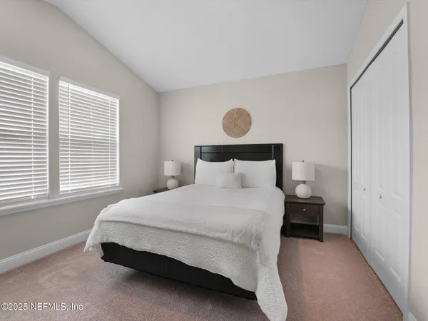 a bedroom with a bed and window
