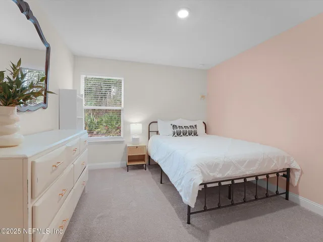 a spacious bedroom with a bed and a window