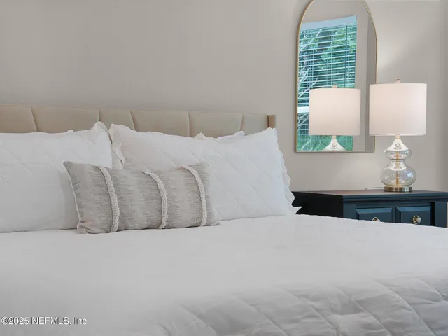 a bedroom with a bed and window