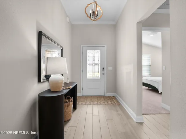 a very nice looking room with wooden floor and a bathroom