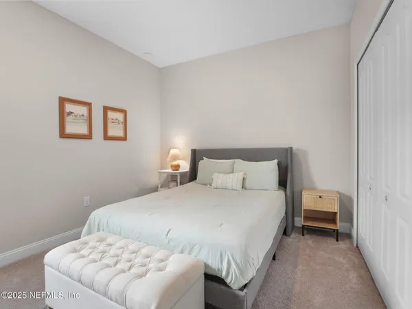 a bedroom with a bed and a couch