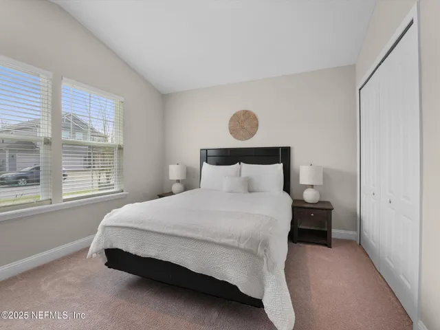 a bedroom with a bed and window