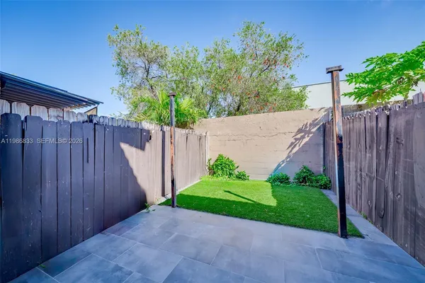 a view of a house with a wooden fence