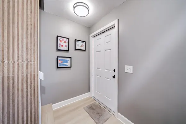 a view of a hallway with paintings on the wall