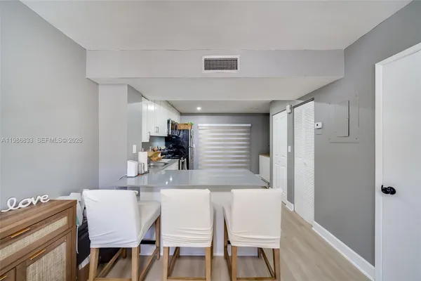 a living room with couches a mirror and a flat screen tv