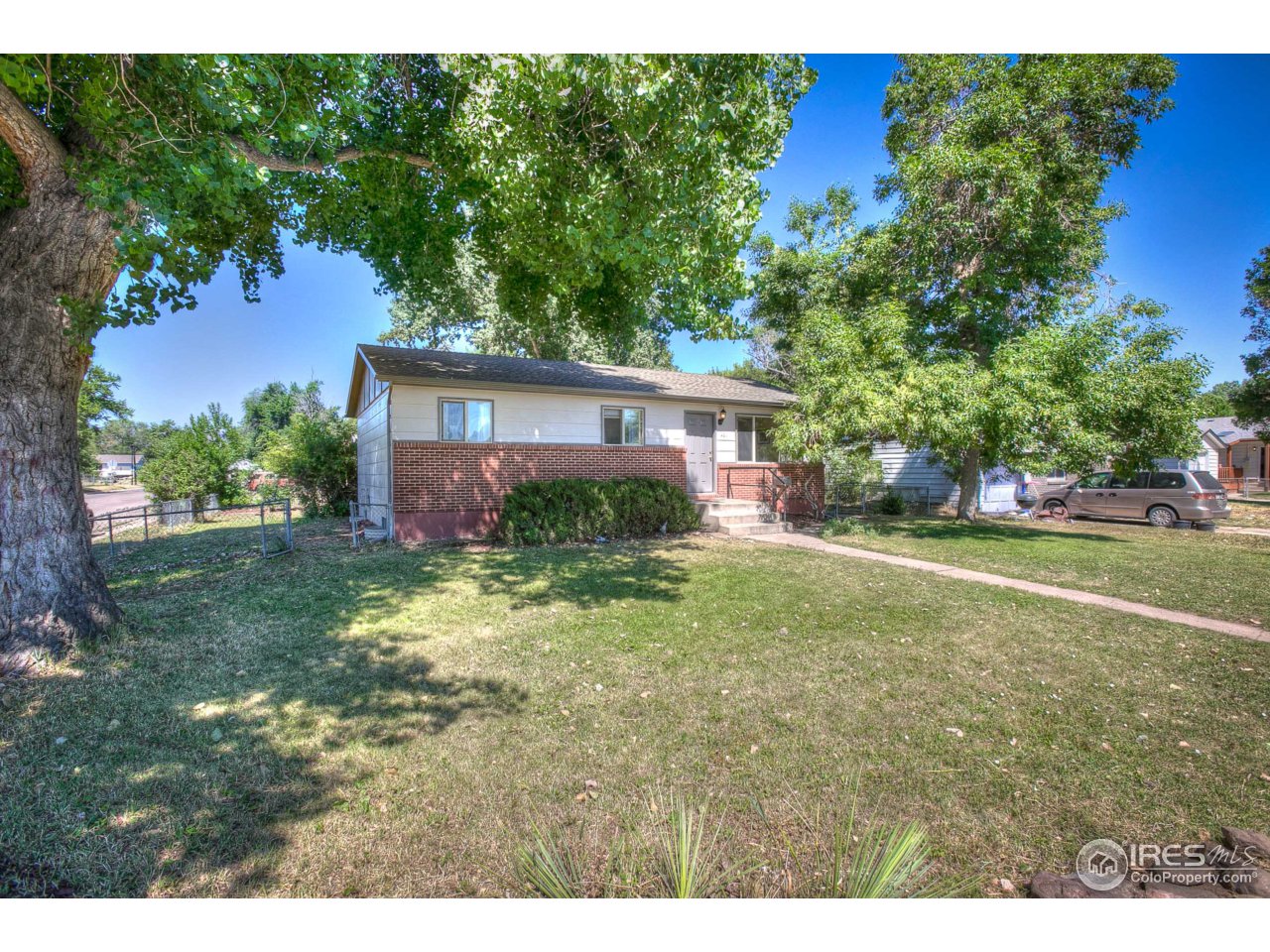 401 Lyons Street Fort Collins, CO 80521 - Photo 1 of 20 a view of a house with a yard