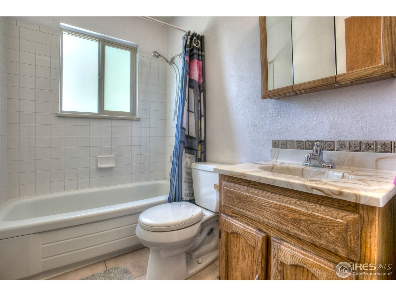 401 Lyons Street Fort Collins, CO 80521 - Photo 13 of 20 a bathroom with a granite countertop toilet sink and mirror