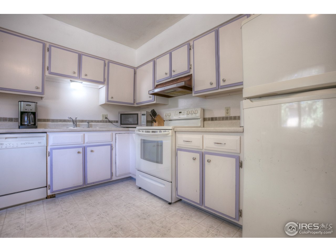 401 Lyons Street Fort Collins, CO 80521 - Photo 8 of 20 a kitchen with white cabinets stainless steel appliances and sink
