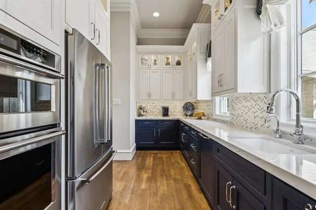 a kitchen with a sink refrigerator and cabinets