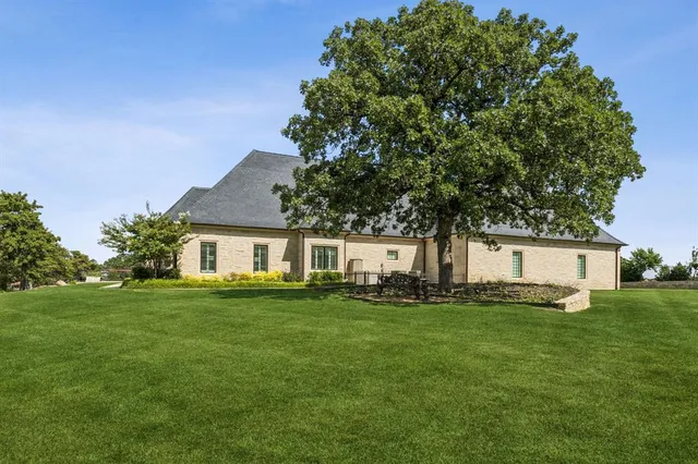 an aerial view of a house with swimming pool and garden