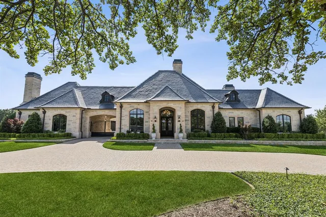 an aerial view of a house with a garden and lake view