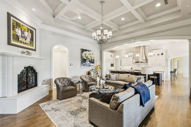 a kitchen with a table chairs stove and wooden floor