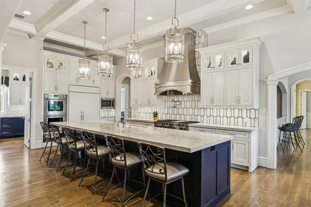 a kitchen with a table chairs and chandelier