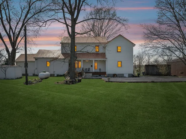 a backyard of a house with lots of green space and lake view