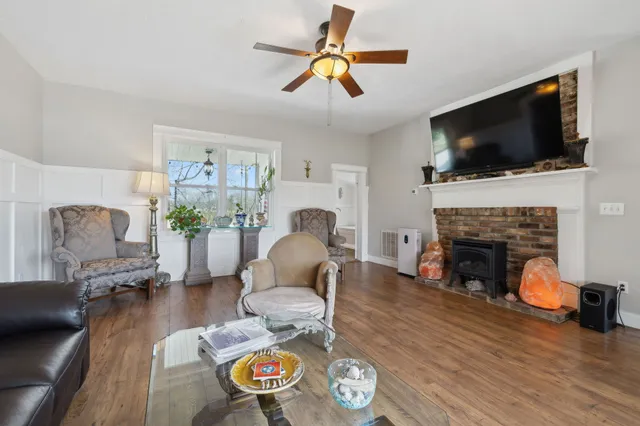a view of a kitchen with fridge and wooden floor