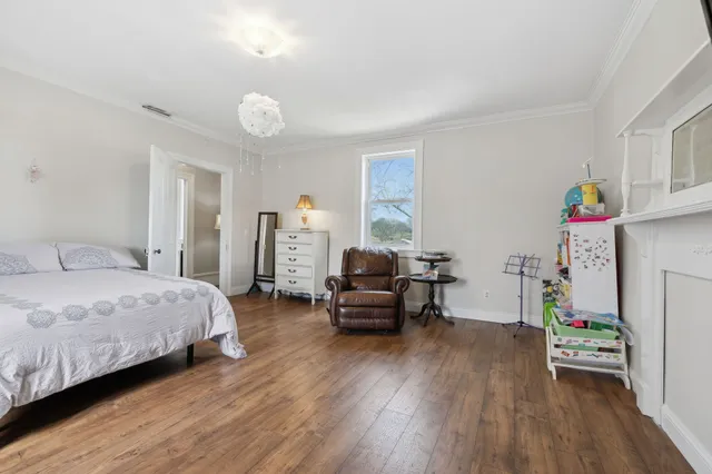 a view of kids room with a large window