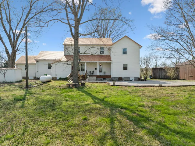 a house that has a tree in front of it