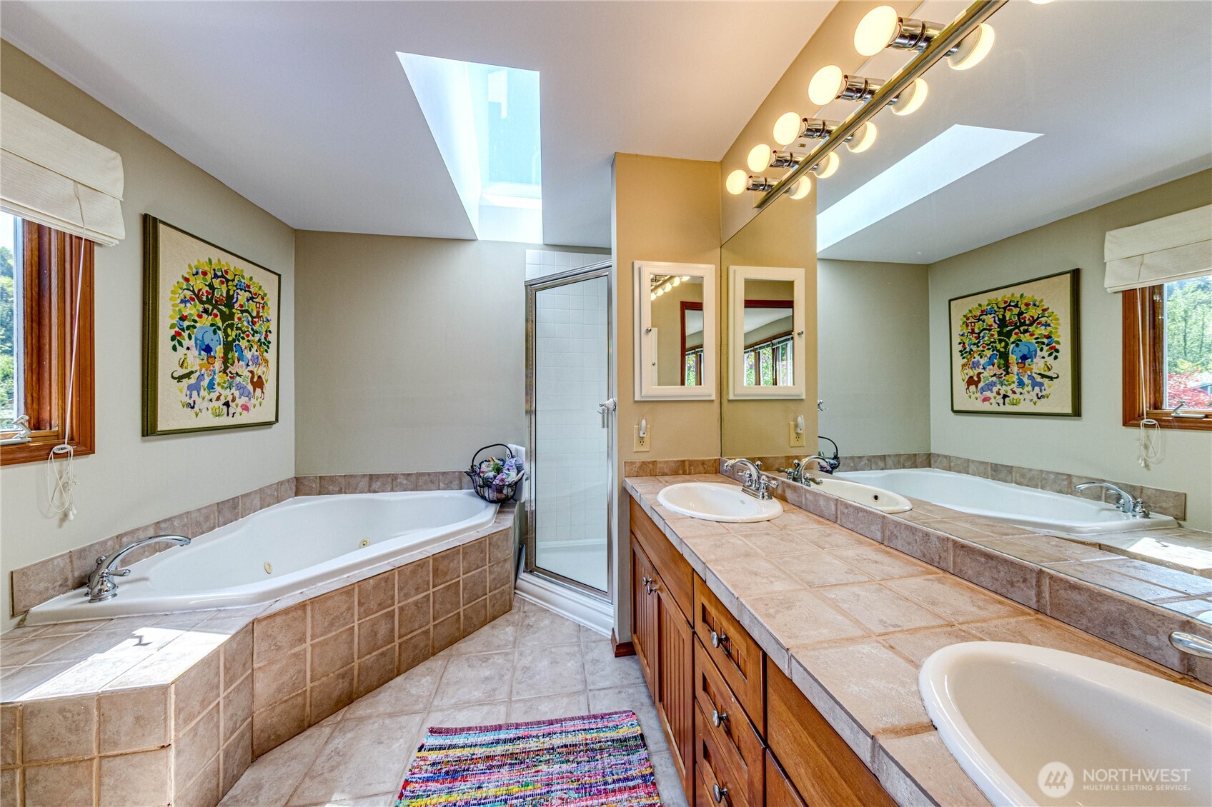 11219 Northeast 174th Street Bothell, WA 98011 - Photo 21 of 40 a spacious bathroom with a granite countertop tub sink and mirror