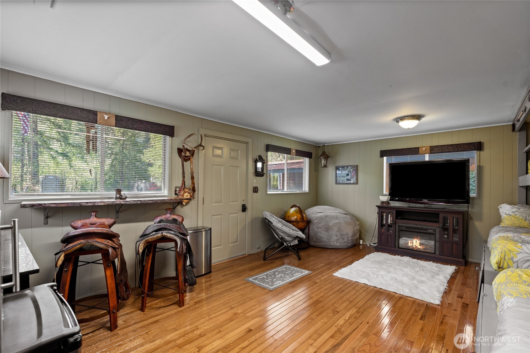 271 Skate Creek Road North Ashford, WA 98304 - Photo 29 of 40 a bedroom with furniture a flat screen tv and a window