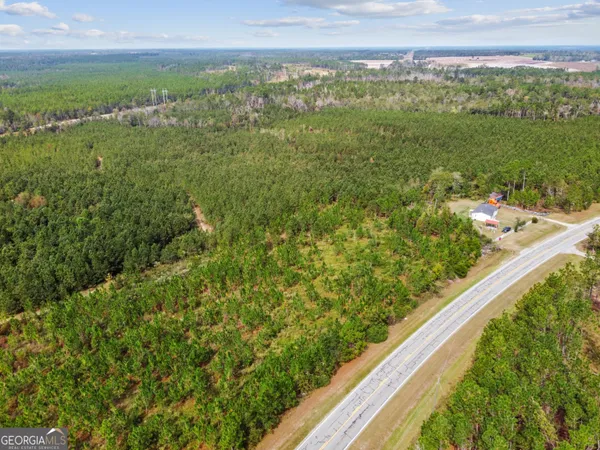 a view of a green field with an ocean view