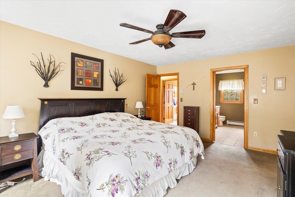 33 Glendale Road Sturbridge, MA 01518 - Photo 15 of 27 a bedroom with a large bed and a chandelier