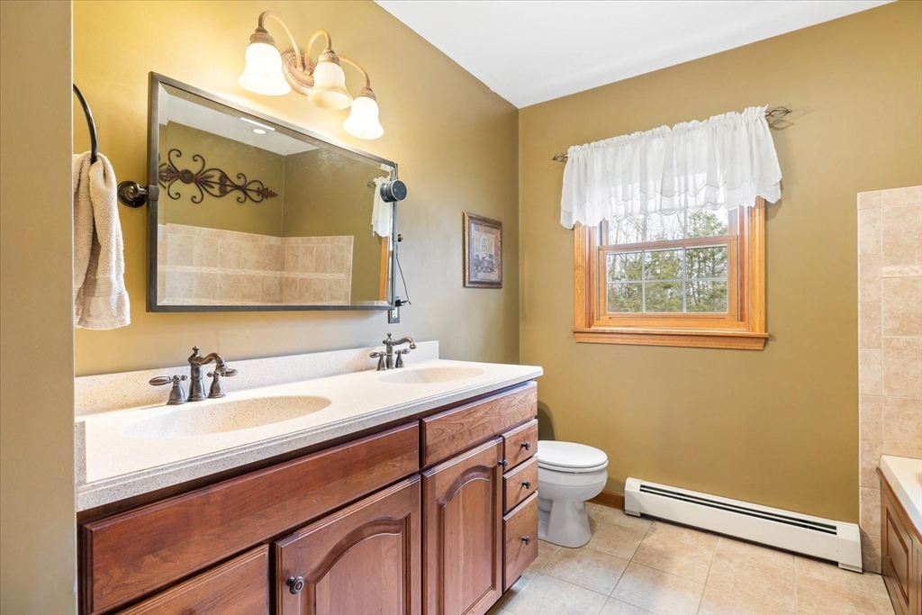 33 Glendale Road Sturbridge, MA 01518 - Photo 17 of 27 a bathroom with a sink a toilet and a mirror