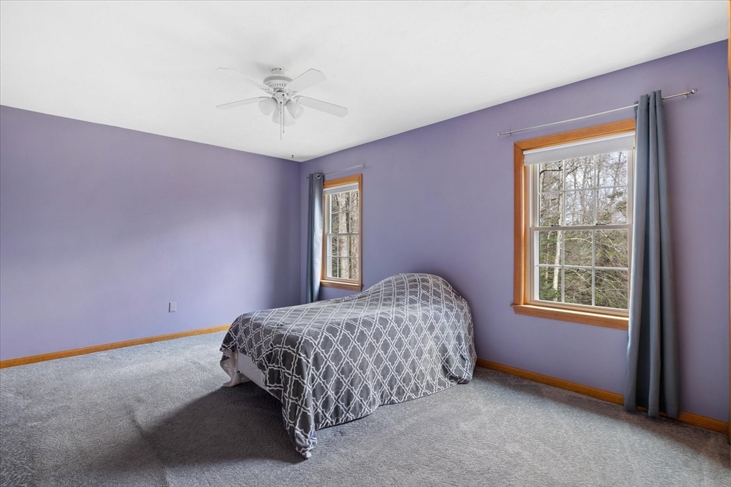33 Glendale Road Sturbridge, MA 01518 - Photo 18 of 27 a bedroom with a bed and a ceiling fan