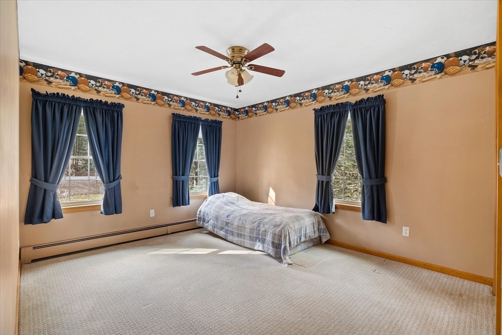 33 Glendale Road Sturbridge, MA 01518 - Photo 19 of 27 a bed room with a bed and a window