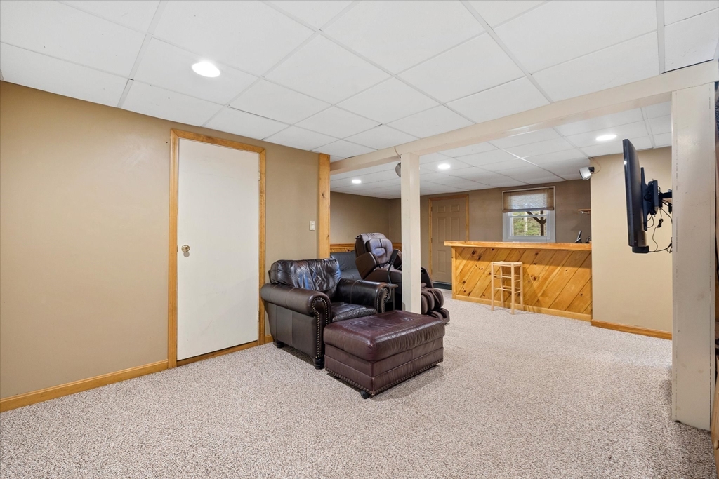 33 Glendale Road Sturbridge, MA 01518 - Photo 22 of 27 a living room with furniture and a flat screen tv