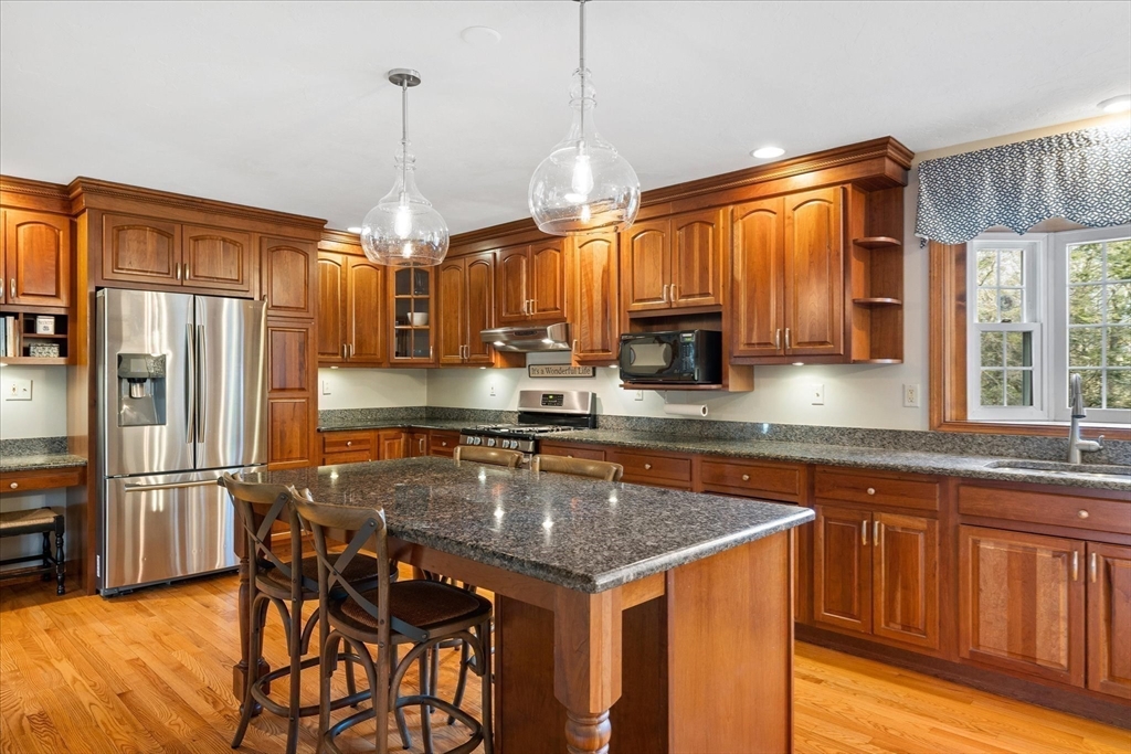 33 Glendale Road Sturbridge, MA 01518 - Photo 5 of 27 a kitchen with stainless steel appliances granite countertop a sink a stove and a refrigerator