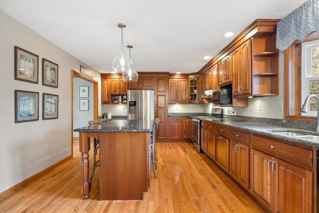 33 Glendale Road Sturbridge, MA 01518 - Photo 6 of 27 a kitchen with stainless steel appliances granite countertop wooden floors and sink