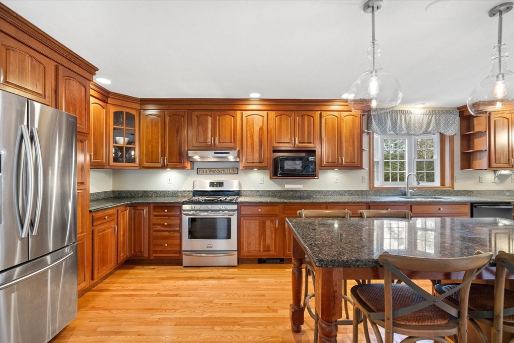 33 Glendale Road Sturbridge, MA 01518 - Photo 7 of 27 a kitchen with stainless steel appliances granite countertop a stove a sink dishwasher a microwave oven with granite countertops and cabinets