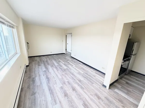 a view of a room with wooden floor and stairs