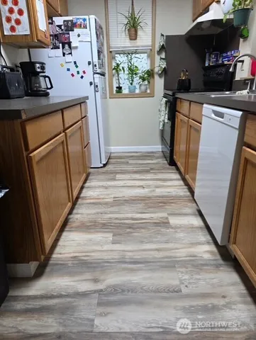 a kitchen with refrigerator and window