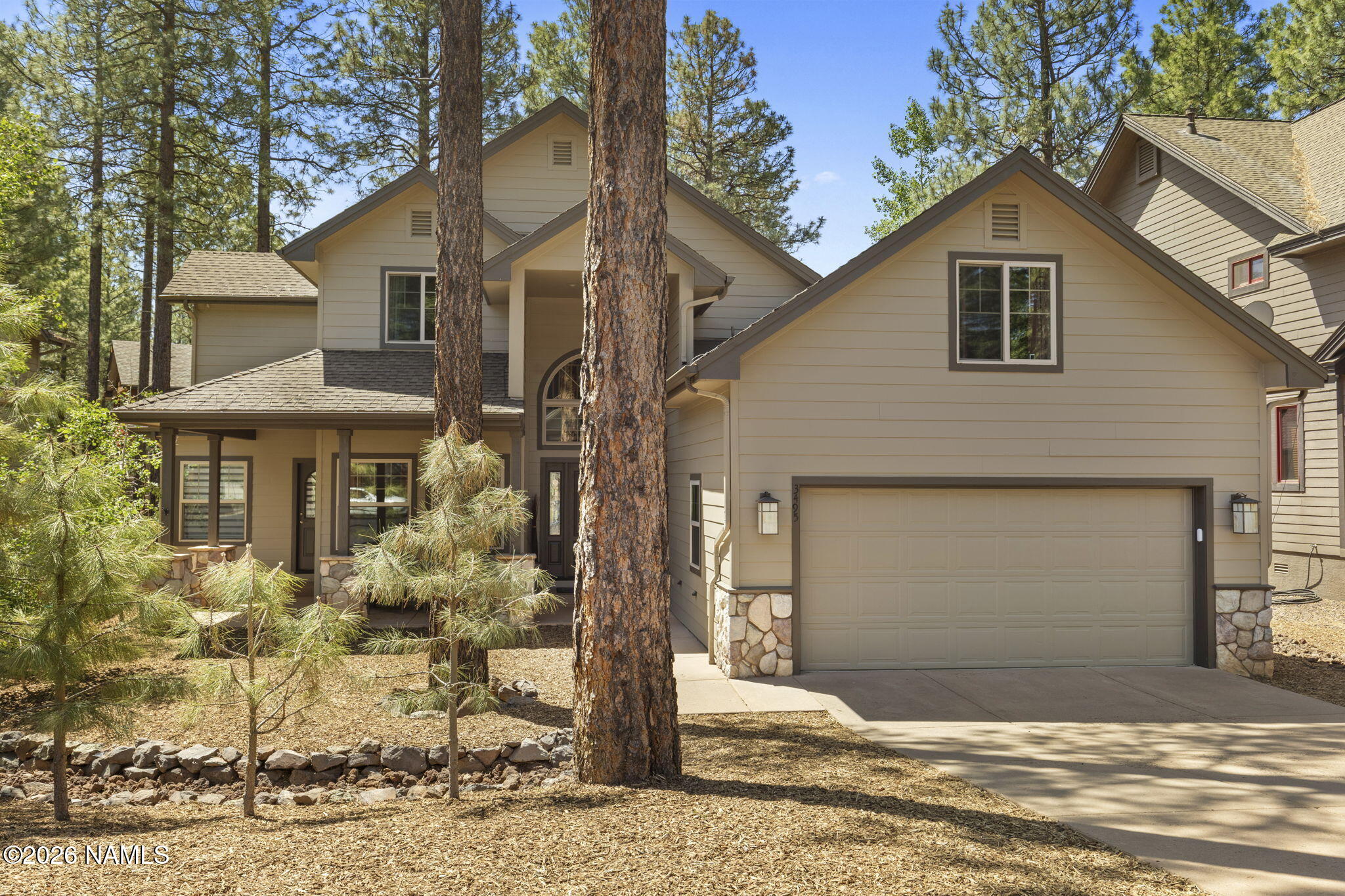 3495 West Lead Rope Flagstaff, AZ 86005 - Photo 2 of 49 a front view of a house with garden