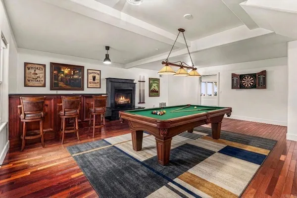 a room with pool table table and paintings on the wall