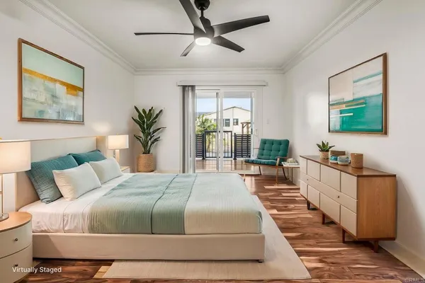 a spacious bedroom with a large bed and a chandelier