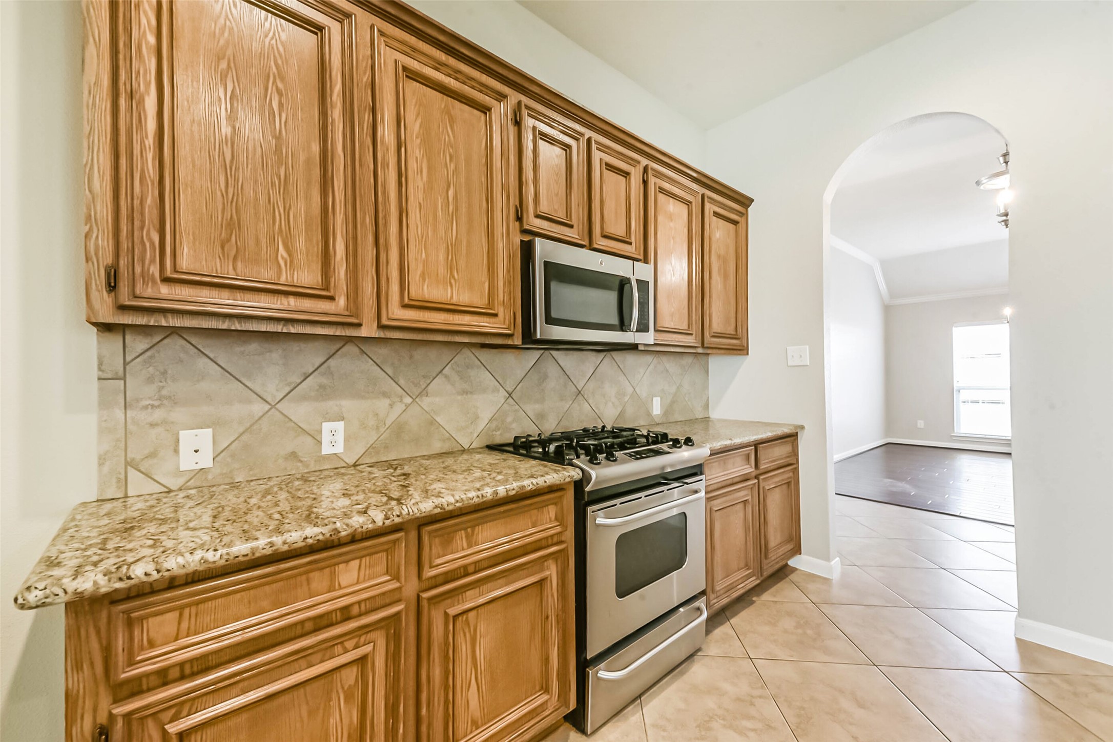 15910 Chart House Court Houston, TX 77044 - Photo 12 of 45 a kitchen with stainless steel appliances granite countertop a stove a sink and a microwave