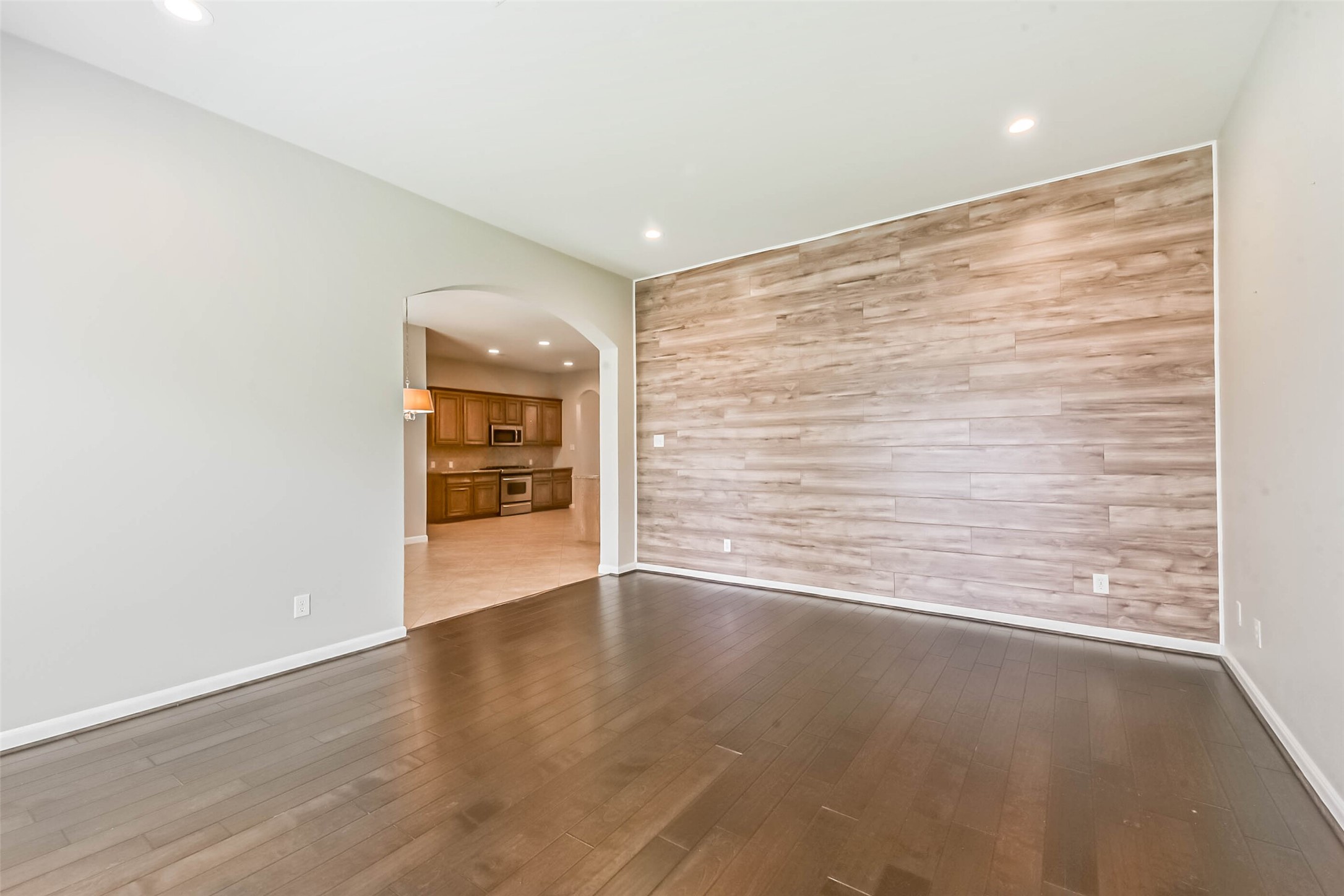 15910 Chart House Court Houston, TX 77044 - Photo 15 of 45 a view of an empty room with a window and wooden floor