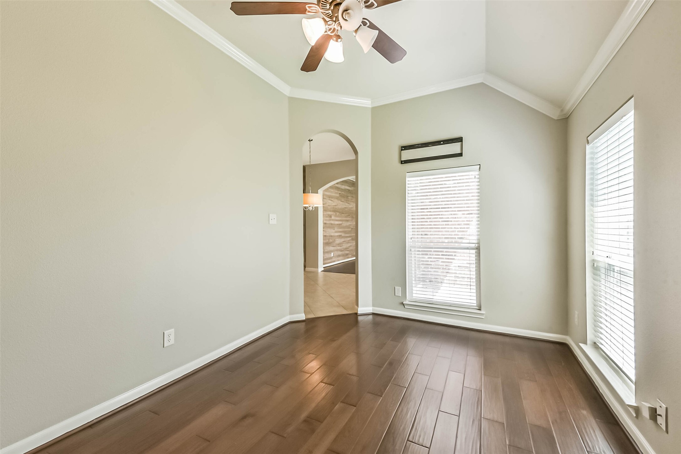 15910 Chart House Court Houston, TX 77044 - Photo 18 of 45 an empty room with wooden floor chandelier fan and windows