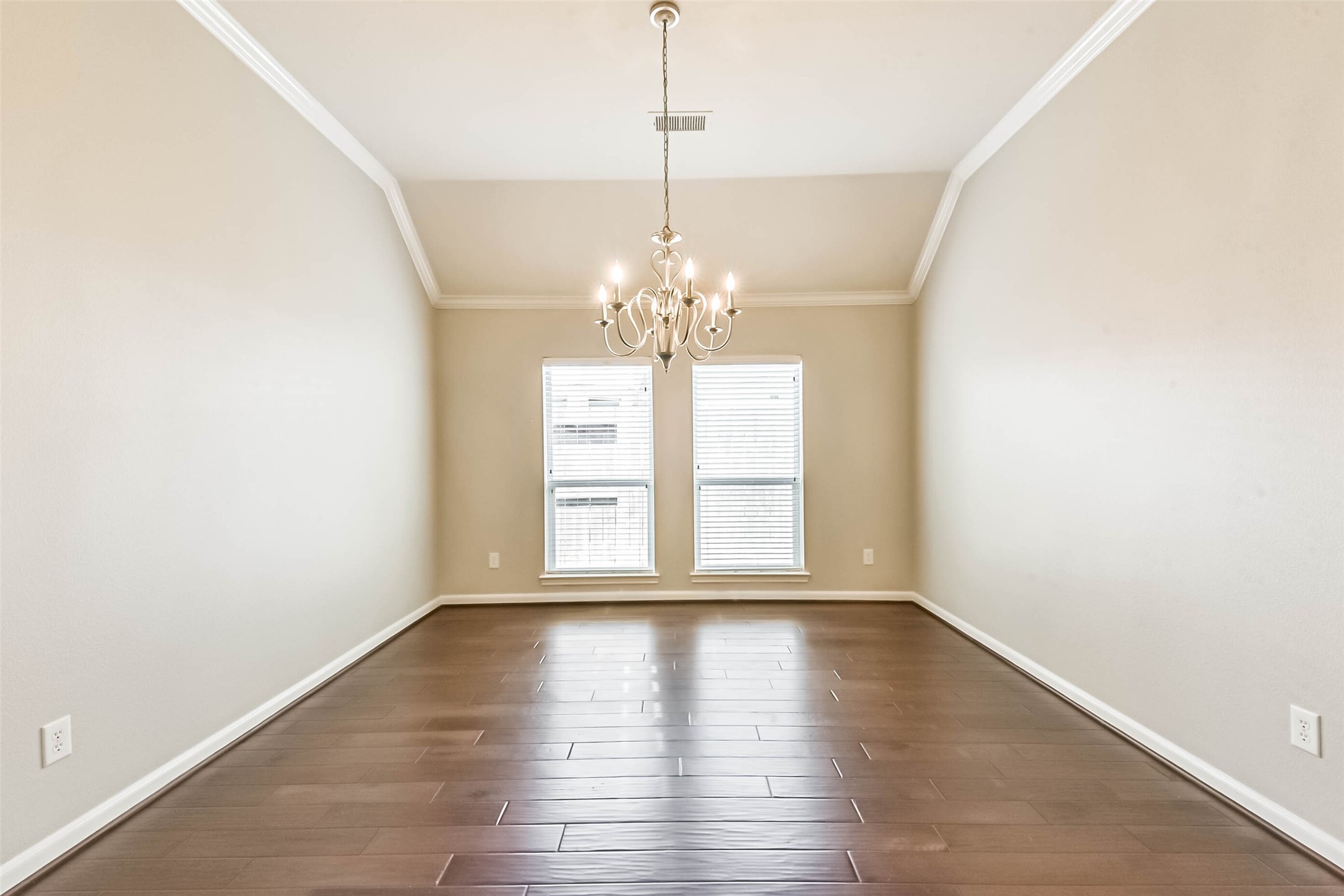 15910 Chart House Court Houston, TX 77044 - Photo 19 of 45 a view of a room with wooden floor and chandelier