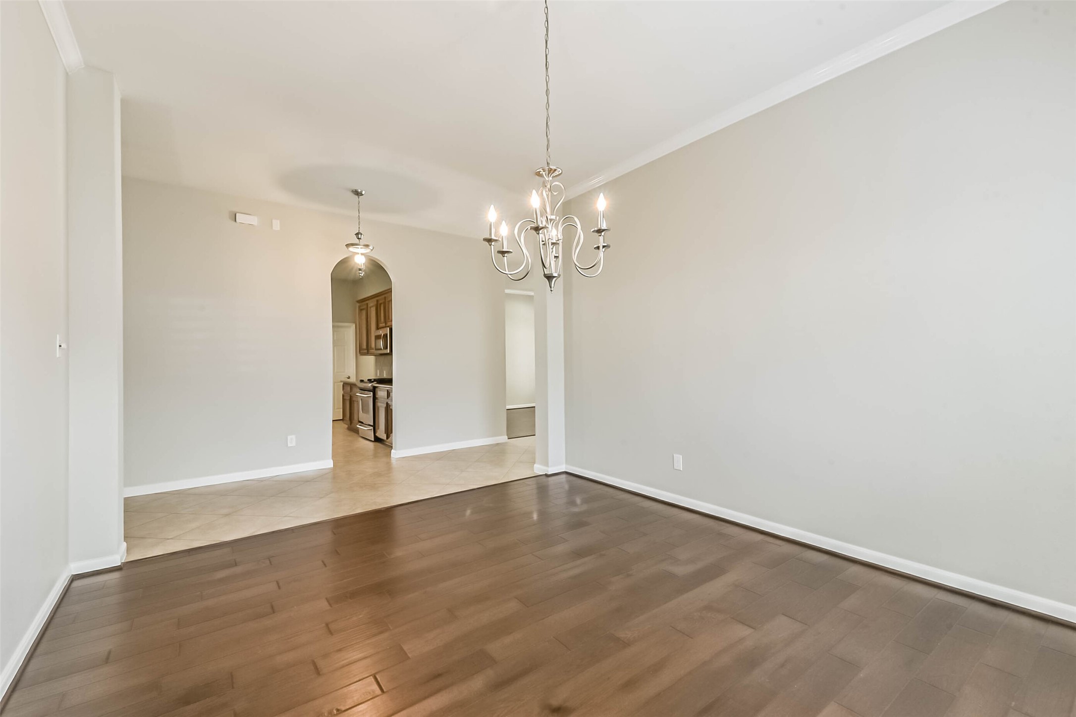 15910 Chart House Court Houston, TX 77044 - Photo 20 of 45 a view of a chandelier in big room with wooden floor
