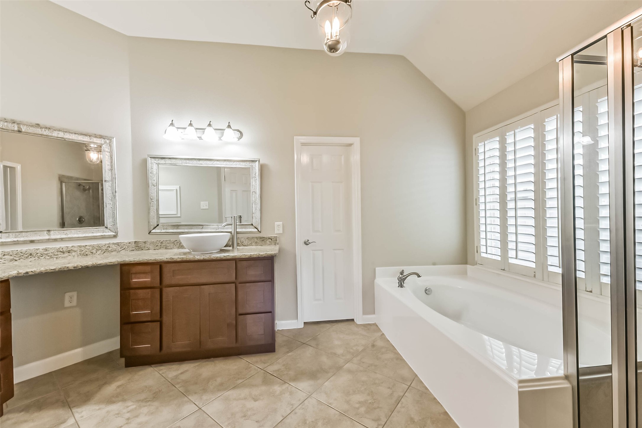 15910 Chart House Court Houston, TX 77044 - Photo 24 of 45 a large spacious bathroom with a tub sink and mirror