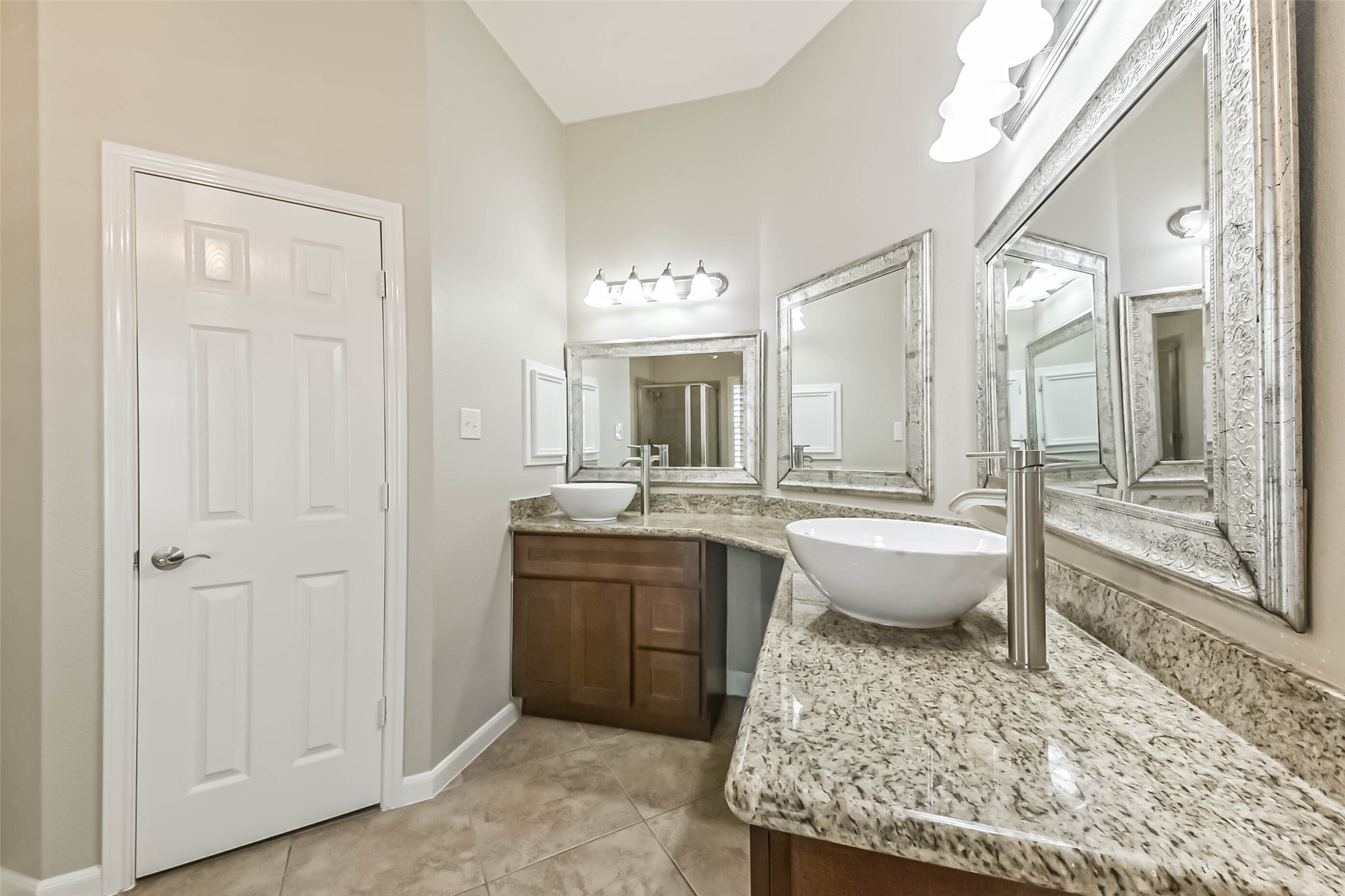 15910 Chart House Court Houston, TX 77044 - Photo 27 of 45 a bathroom with a granite countertop tub sink and mirror