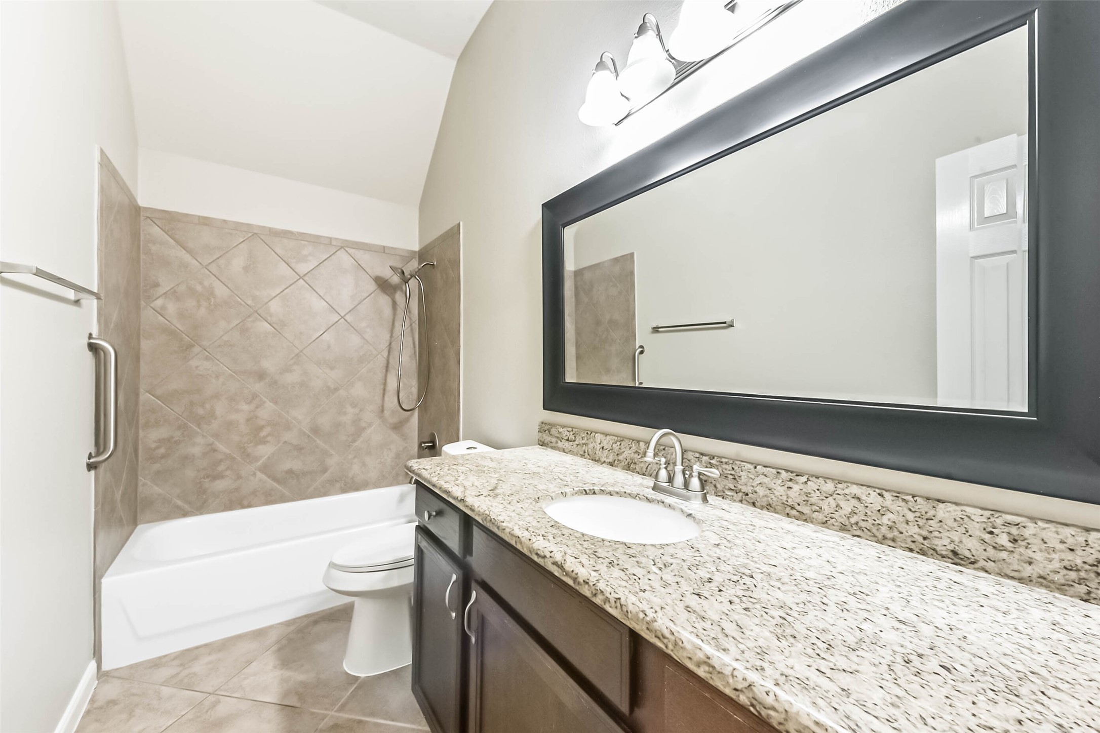 15910 Chart House Court Houston, TX 77044 - Photo 39 of 45 a bathroom with a granite countertop sink a mirror a toilet and bathtub